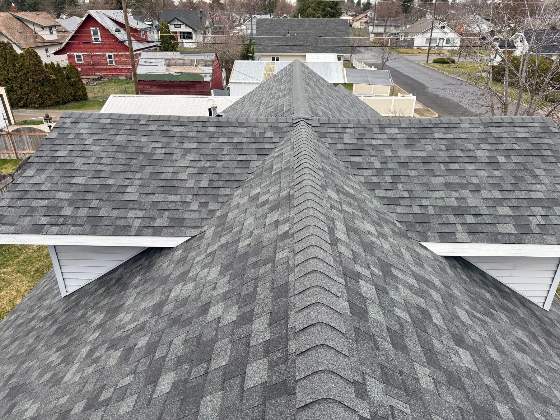 Ridge Roofing asphalt shingle project viewed along a roof ridge